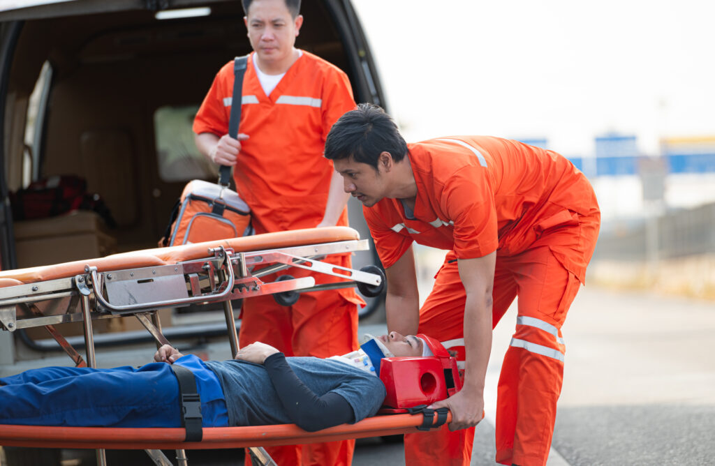 a paramedic loading up an injured person onto a vehicle