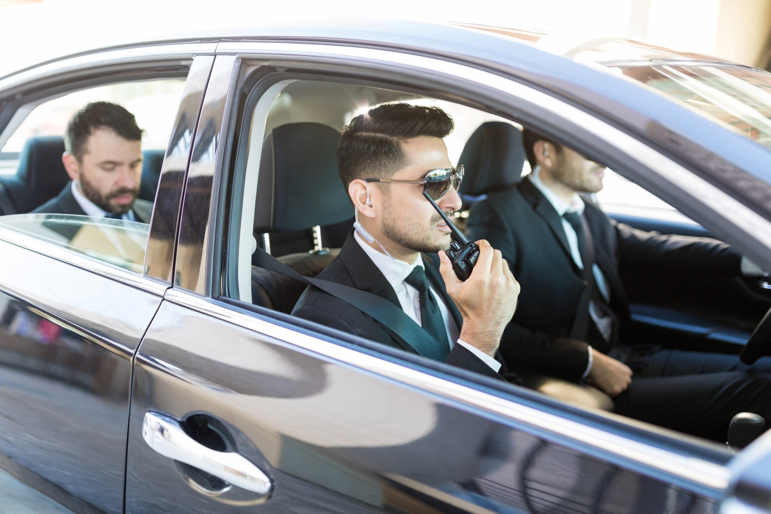 Corporate travel management coordination team inside a car updating all drivers.