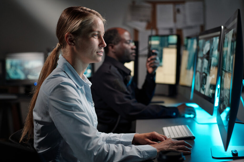 Emergency response team monitoring global threats through computers.