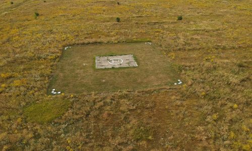 helicopter landing place in the field at summer day, aerial view.