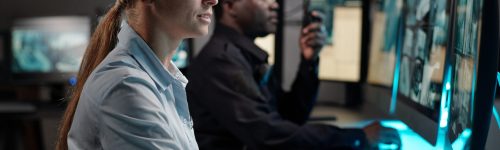 Emergency response team monitoring global threats through computers.