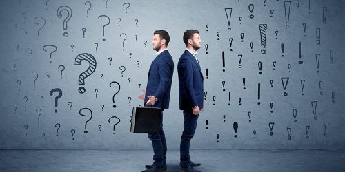 young-conflicted-businessman-choosing-between-two-20